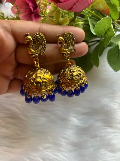 One of my bestselling designs, these gold-oxidised jhumkas with a peacock stud and royal blue beads are always a hit at my offline events.