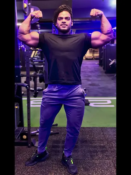 You can change your circumstances by changing your attitude. A bodybuilder showcases his impressive physique with a powerful front double biceps pose.