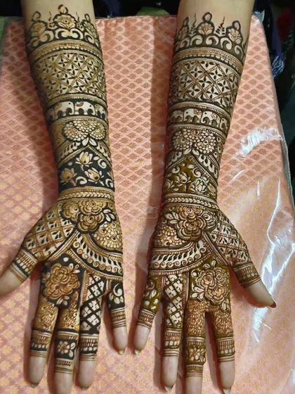 An elegant bridal design that combines floral bands with geometric patterns. The contrast between the delicate flowers and the structured check-work creates a visually stunning effect from wrist to elbow.