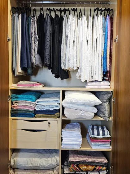 A dedicated linen closet brings a sense of calm to the entire home. Here, everything from bedsheets and pillows to towels and rugs has its own designated spot. Hanging bedsheets is a game-changer for preventing wrinkles and saving space.