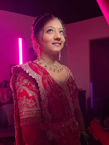 The bride looking up, with the party lights creating a beautiful glow on her skin.