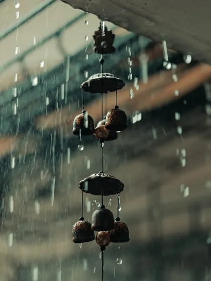 A wind chime in the rain. The edit freezes the motion of the raindrops and adds a dark, moody atmosphere.