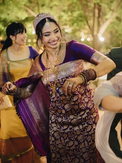 A couple shares a laugh during their dance performance, a candid moment of joy.