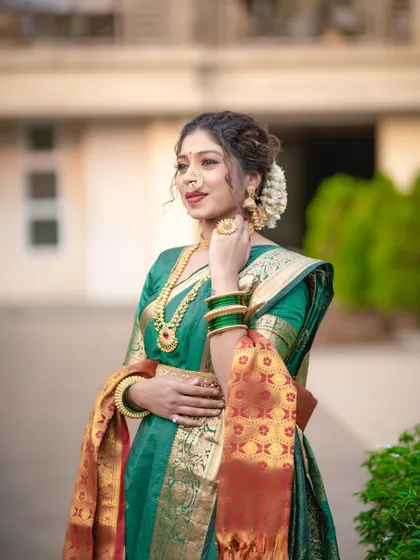 A close-up of the model, highlighting her traditional jewellery and confident expression.