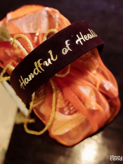 A beautifully packaged wedding favor with a custom tag that reads 'A Handful of Health'. Thoughtful gifts show guests how much they are appreciated.