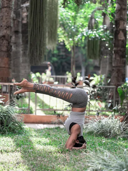 Finding balance in a variation of Sirsasana, or Headstand. Inversions calm the brain by increasing blood flow, helping us to find that quiet space that Patanjali speaks of.
