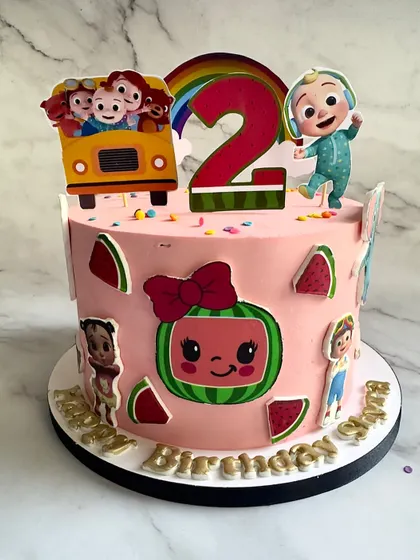 Another take on the popular Cocomelon theme, this time for a 2nd birthday. The cake is decorated with characters from the show, a bright rainbow, and the iconic yellow school bus.