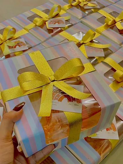 A close-up of the first birthday candle set, showing the elegant packaging and the variety of candle shapes included in this unique favor.