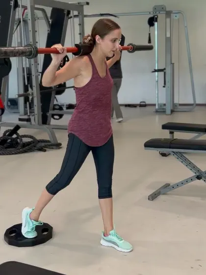 My client working on her balance and leg strength with a barbell exercise.