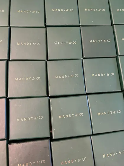 A grid of my signature Mandy & Co. hard boxes, showcasing my premium packaging for bulk orders.