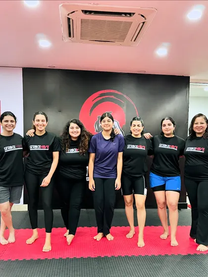 The women of StrikeHive posing together after a challenging training session. We celebrate the camaraderie and mutual support that defines our community.