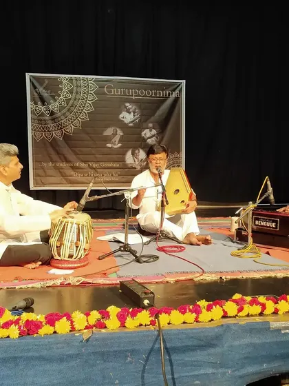 Another performance from the Gurupoornima stage, featuring vocal, tabla, and harmonium. The event is a celebration of all forms of Hindustani classical music.