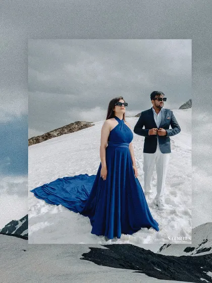 A creative, framed portrait of the couple against the dramatic, snowy landscape of Kashmir.
