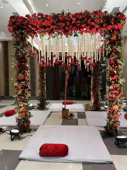 The mandap is the most sacred space at a wedding, and we decorate it with care. This beautiful mandap is constructed with pillars of red roses and a ceiling of hanging white flowers (kaleeras).