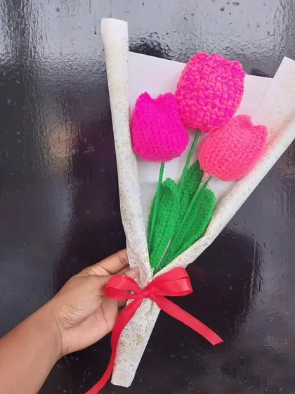 A vibrant bouquet of handmade crochet tulips. These are a wonderful way to add a pop of color to any room, and they never need watering.