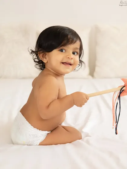 A happy baby in a diaper is a classic for a reason. This shot is all about chubby rolls and happy smiles.