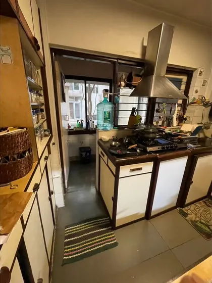 **BEFORE:** A view of the old kitchen showing the small utility balcony at the back, which was separated from the main cooking area.