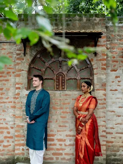 The anticipation of the first look. The couple stands on either side of a wall, a creative and emotional shot before the big reveal.