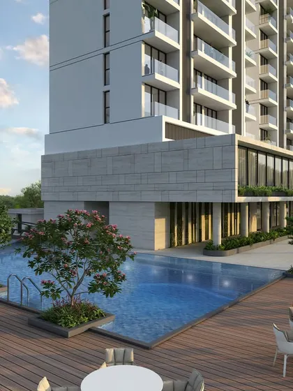 The poolside deck at our twin-tower project in Nashik. This expansive outdoor area is part of a 75,000 sq. ft. amenity space, designed with comfortable seating and beautiful landscaping for residents to relax and socialize.