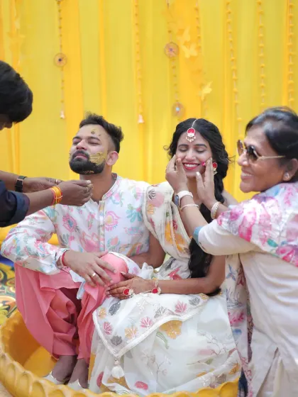 Capturing the joy of a Haldi ceremony. This candid shot shows the couple enjoying their ritual, with makeup that is both radiant and durable enough to withstand all the fun and emotions of the day.