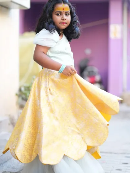 One of the lovely twins of Aarvi, twirling in her custom lehenga with a scalloped hem.