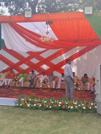 This is a VIP lounge area I set up inside a tent for a political event. It features tricolor fabric draping, plush sofas for dignitaries, and practical additions like air coolers to ensure comfort.