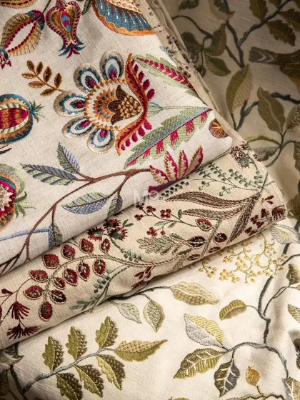 A close-up of the handwoven fabrics from our "Nature's Symphony" collection, highlighting the detailed embroidery and rich, earthy color palette.