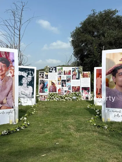 A deeply personal and romantic outdoor proposal setup, featuring a gallery of the couple's memories on large, custom-printed photo boards. I love weaving your personal story into every element of the decor.