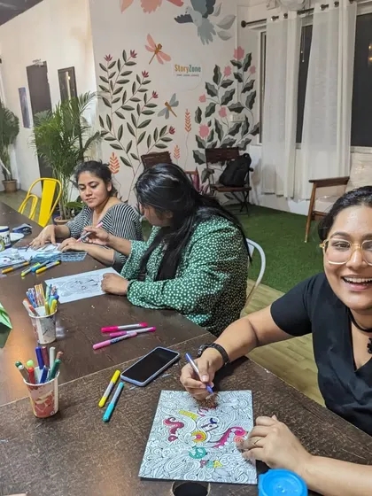 A participant smiling and enjoying a relaxing coloring session during our DIY Menu launch event.