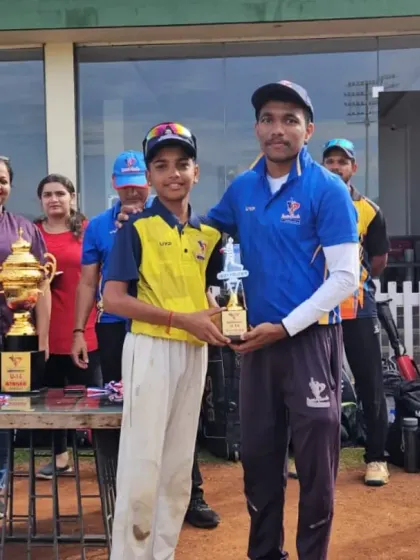 An award winner from the U-12/U-14 tournament poses with his coach, showcasing the strong mentor-student bond we cultivate.