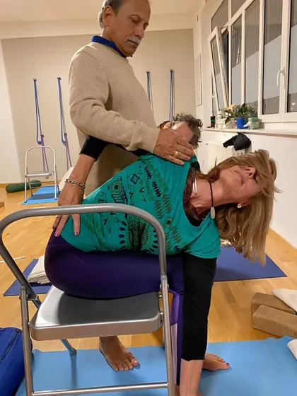Providing a gentle, hands-on adjustment to a student in Geneva. I believe in giving personal attention to each practitioner, ensuring they practice safely and effectively, no matter their level of experience.