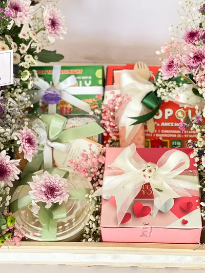 A close-up of the anniversary food hamper, showing the delicious cakes and treats wrapped with love and heart details. It’s a sweet and sentimental way to celebrate another year together.