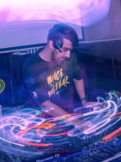 A creative long-exposure shot capturing the movement and energy of me at the decks. This photo visualizes the flow of music and motion.