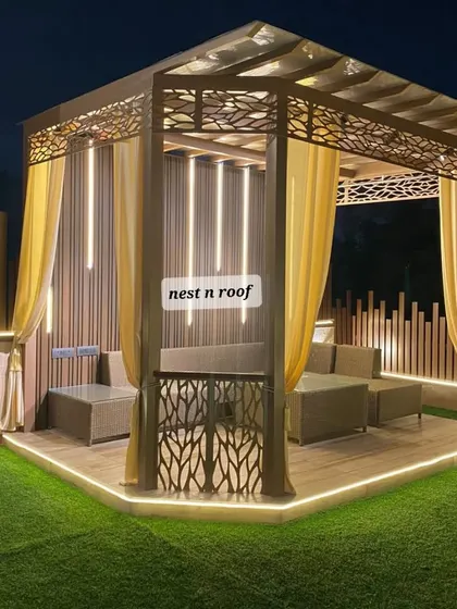 This elegant gazebo is the centerpiece of a beautiful terrace garden. We designed it with intricate laser-cut panels and flowing curtains, creating a private and luxurious outdoor seating area perfect for any weather.