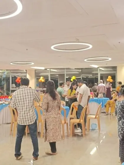Guests enjoying the food and atmosphere at a birthday celebration. We manage the entire food service, from setup to serving, allowing you to be a guest at your own party.