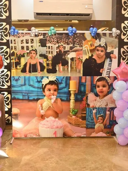 A personalized photo collage backdrop for a first birthday party. This is a great way to showcase memories from the baby's first year.