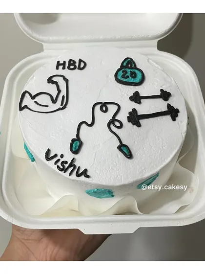 A fitness-themed bento cake with drawings of weights, dumbbells, and a skipping rope.