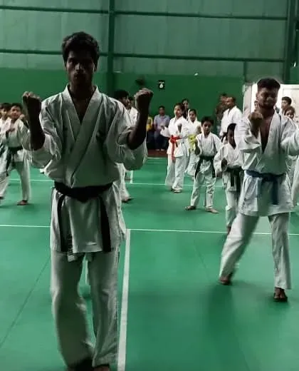 Senior and junior students practicing their basic stances and punches during a belt exam. Fundamentals are the core of our teaching.