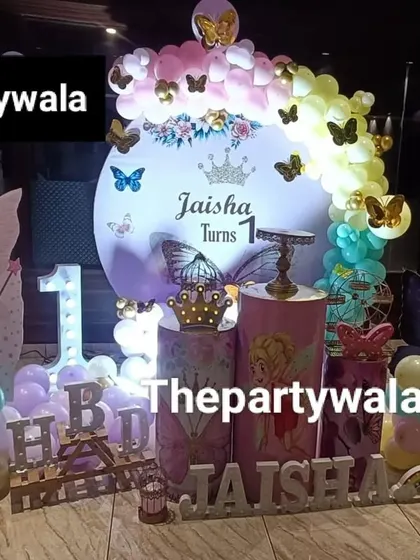 A fairy tale theme with a 'Jaisha Turns 1' backdrop and a personalized photo board.