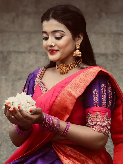 The rich texture of the Kanjeevaram silk and the detailed embroidery on the blouse sleeves are what make this half saree special.