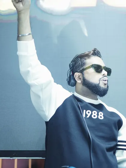 I make vibes, not noise. An action shot of me with my arm raised, feeling the music during a set.