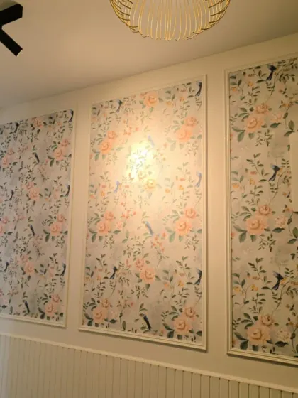Another view of the framed floral wallpaper, showing the full series of panels.
