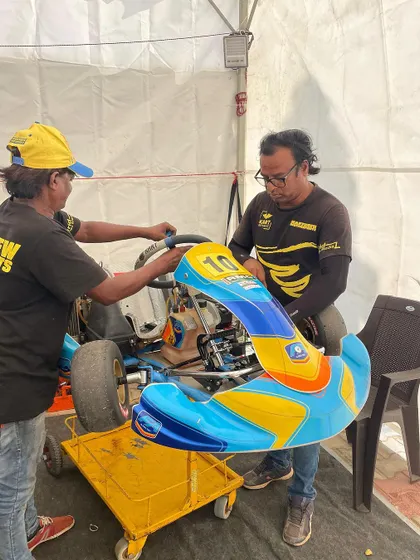 Our mechanics work on a micro-max kart in the pit tent. We provide the same level of professional technical support to our youngest drivers as we do for our seniors.
