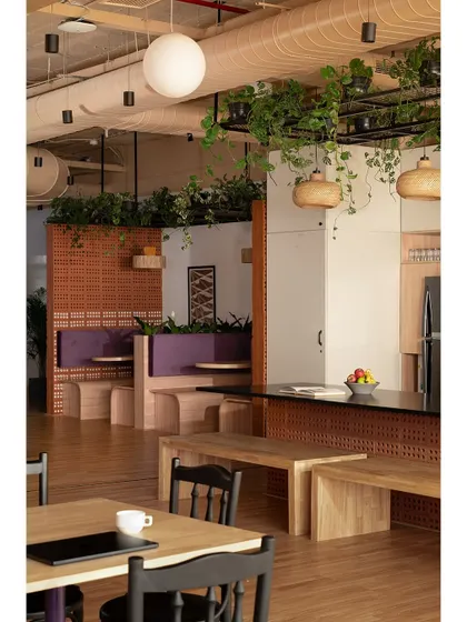 This view shows how we integrated different zones within the common area. The seating niches offer a cozy alternative to open tables, providing employees with a choice of environments depending on their task or mood.