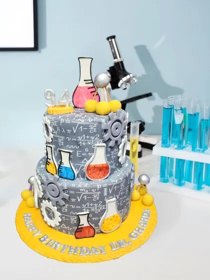 For the science whiz in your life, this two-tier cake is covered in edible equations, beakers, and gears. It was a fun challenge to create this detailed science lab theme for a 94th birthday.