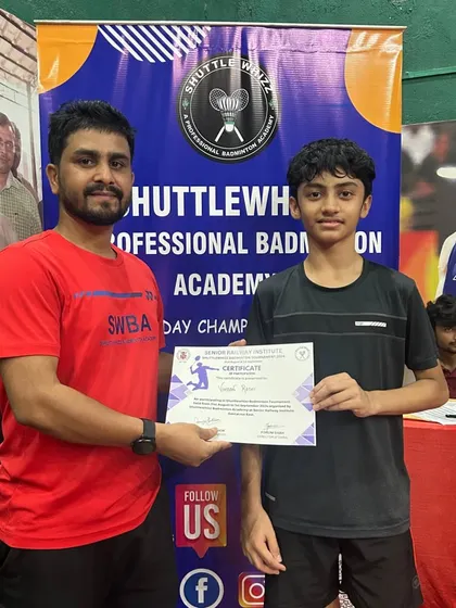 A coach congratulates a student during the certificate distribution at our 2024 in-house tournament, fostering a sense of achievement.