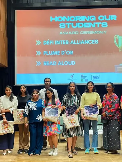A group photo of all the student winners on stage during the Bastille Day award ceremony. We are incredibly proud of our students' hard work and achievements in various national and international competitions.