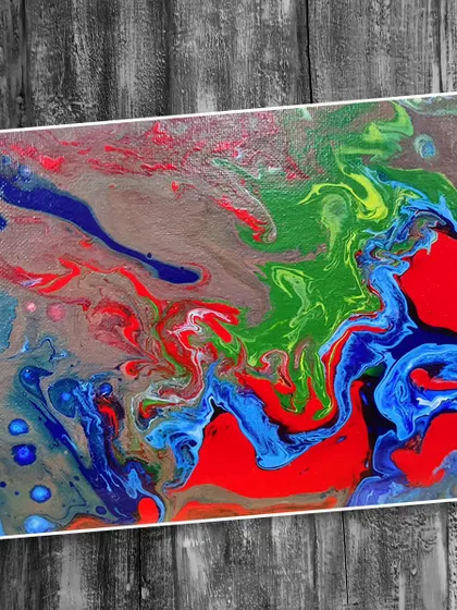 A powerful abstract piece made with red, blue, and green fluid paints. We encourage students to experiment and find their own style with this versatile medium.