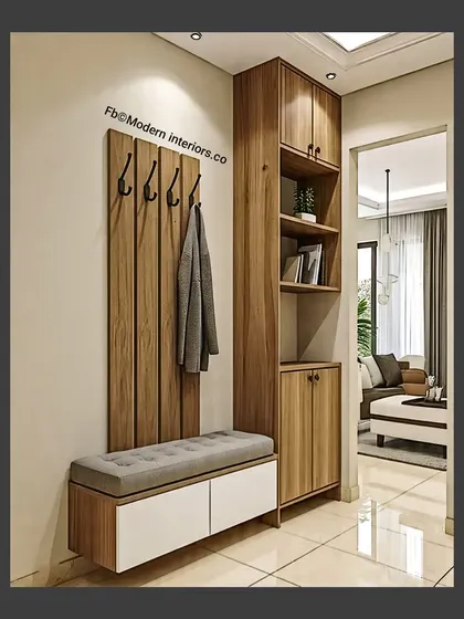 A simple and effective entryway design with a seating bench, coat hooks, and a tall storage cabinet. The view into the living room shows how a well-designed foyer can set the tone for the whole home.