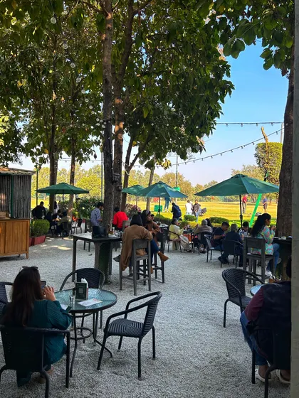 Another view of the relaxed atmosphere on our patio, where guests can watch golfers on the range while they dine.